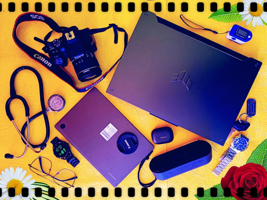 Creative workspace flat lay with laptop, tablet, stethoscope, camera and accessories on yellow background